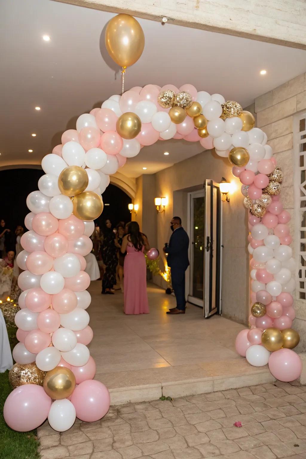 A striking balloon arch in rose, gold, and ivory cordially welcomes visitors.
