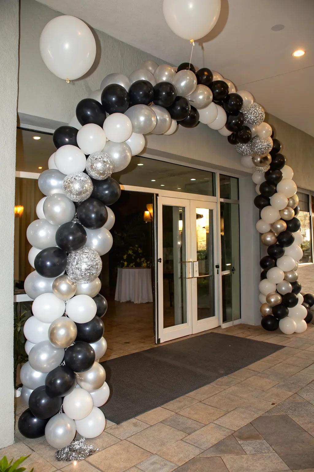 An exquisite balloon garland rendered in black, silver, and white.
