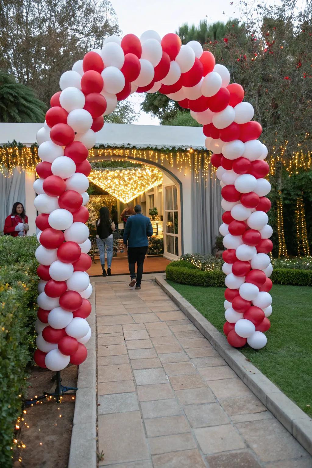 Receive your attendees with an adorable peppermint stick balloon gateway.
