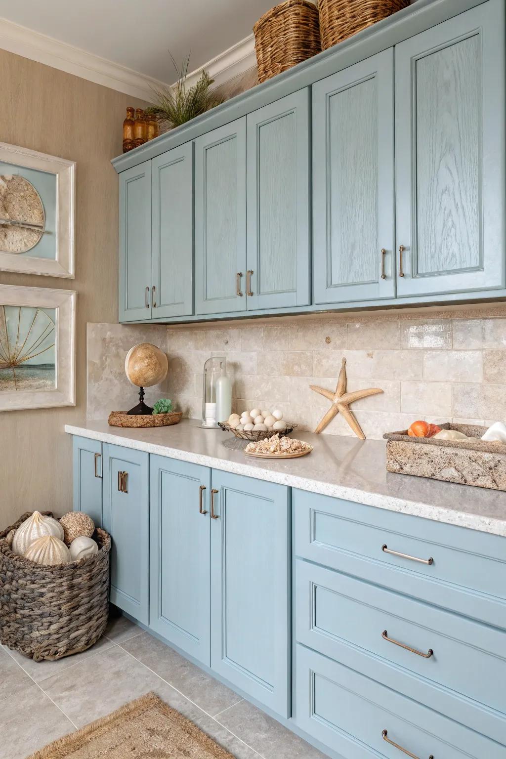 A kitchen inspired by coastal hues, featuring soft blues and sandy creams.