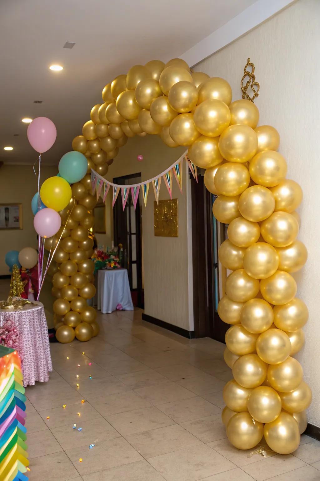 An impressive gold balloon arch creating a lavish entrance.
