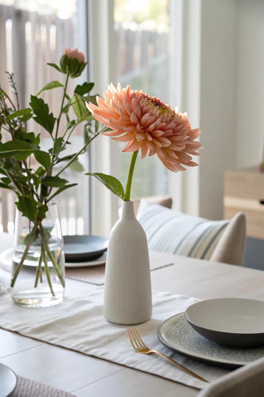 A minimalist centerpiece featuring a single flower in a container.