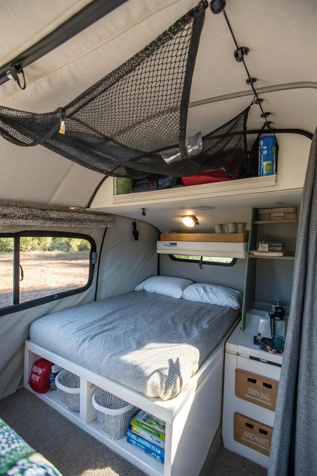 Ceiling storage nets inside a camper help keep lightweight items organized.