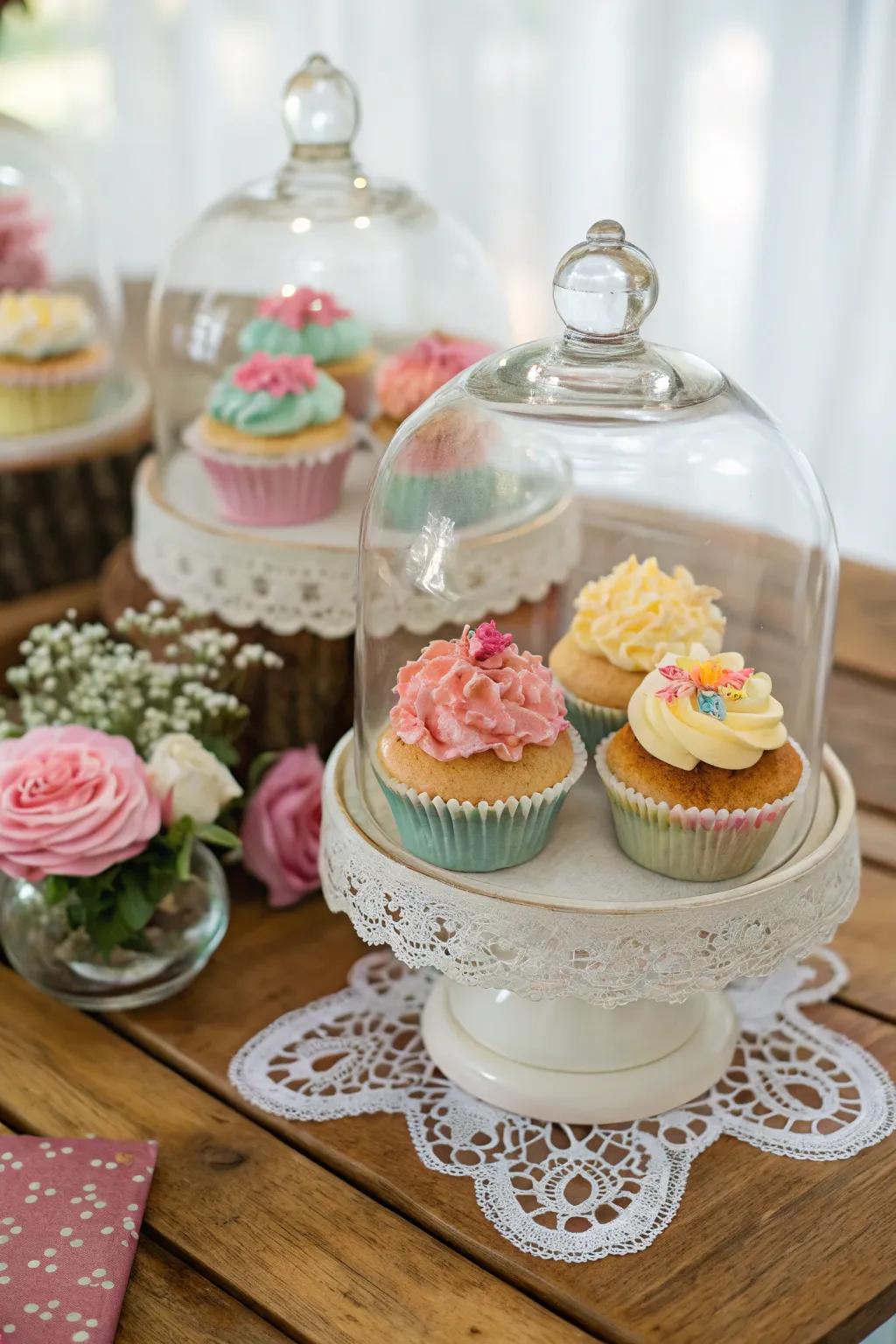 Glass domes enhancing sophistication and elegance to the cupcake presentation.
