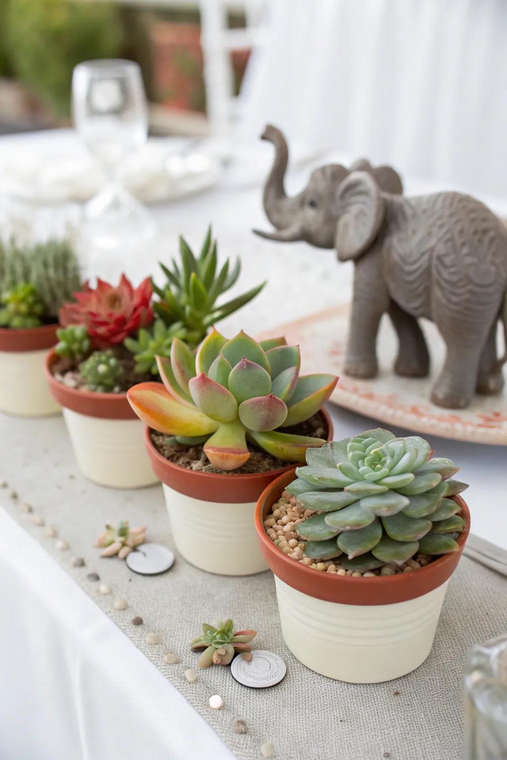 Fashionable centerpiece pairing elephants with succulents.