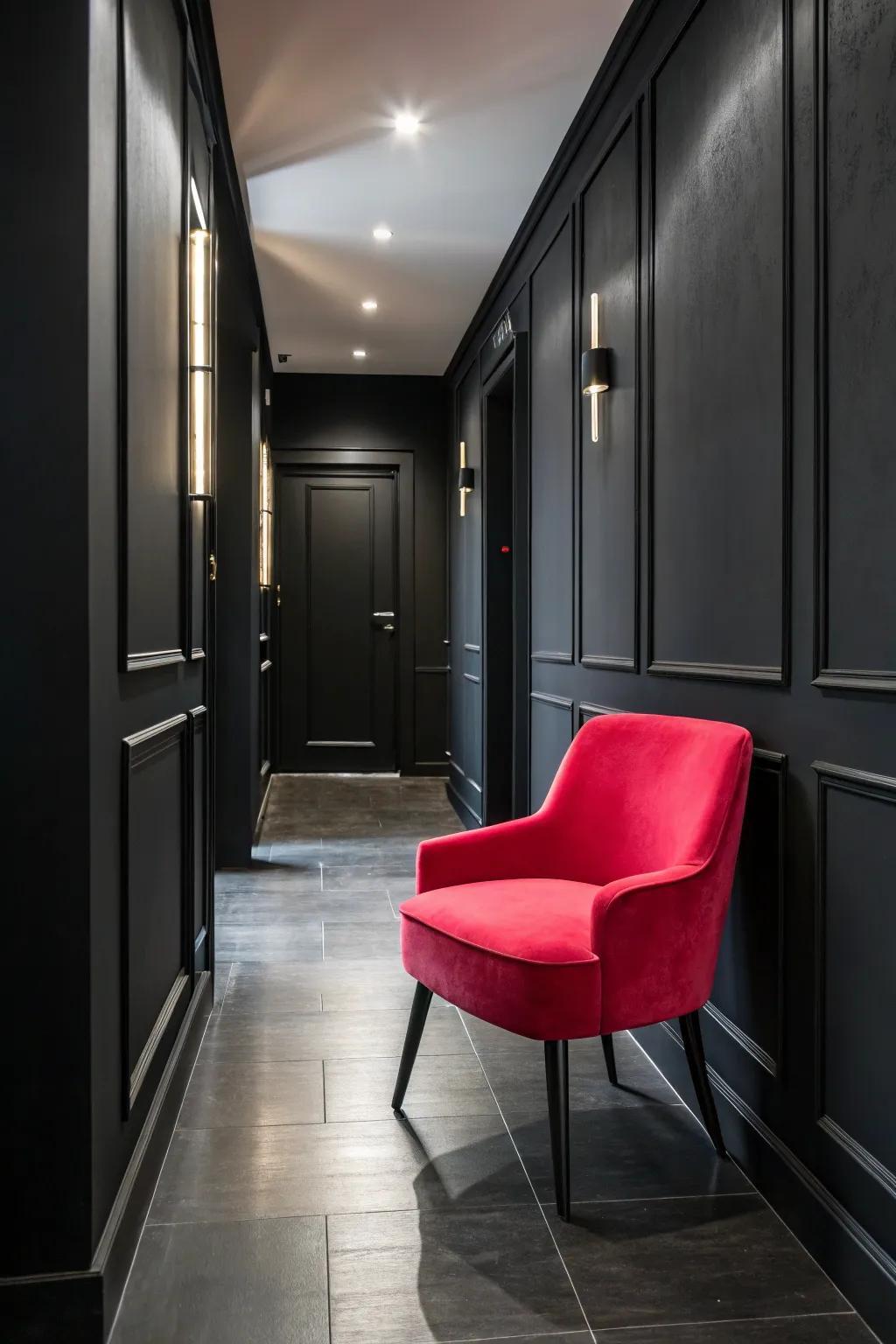 A bold-colored highlight chair infuses character into a black hallway.