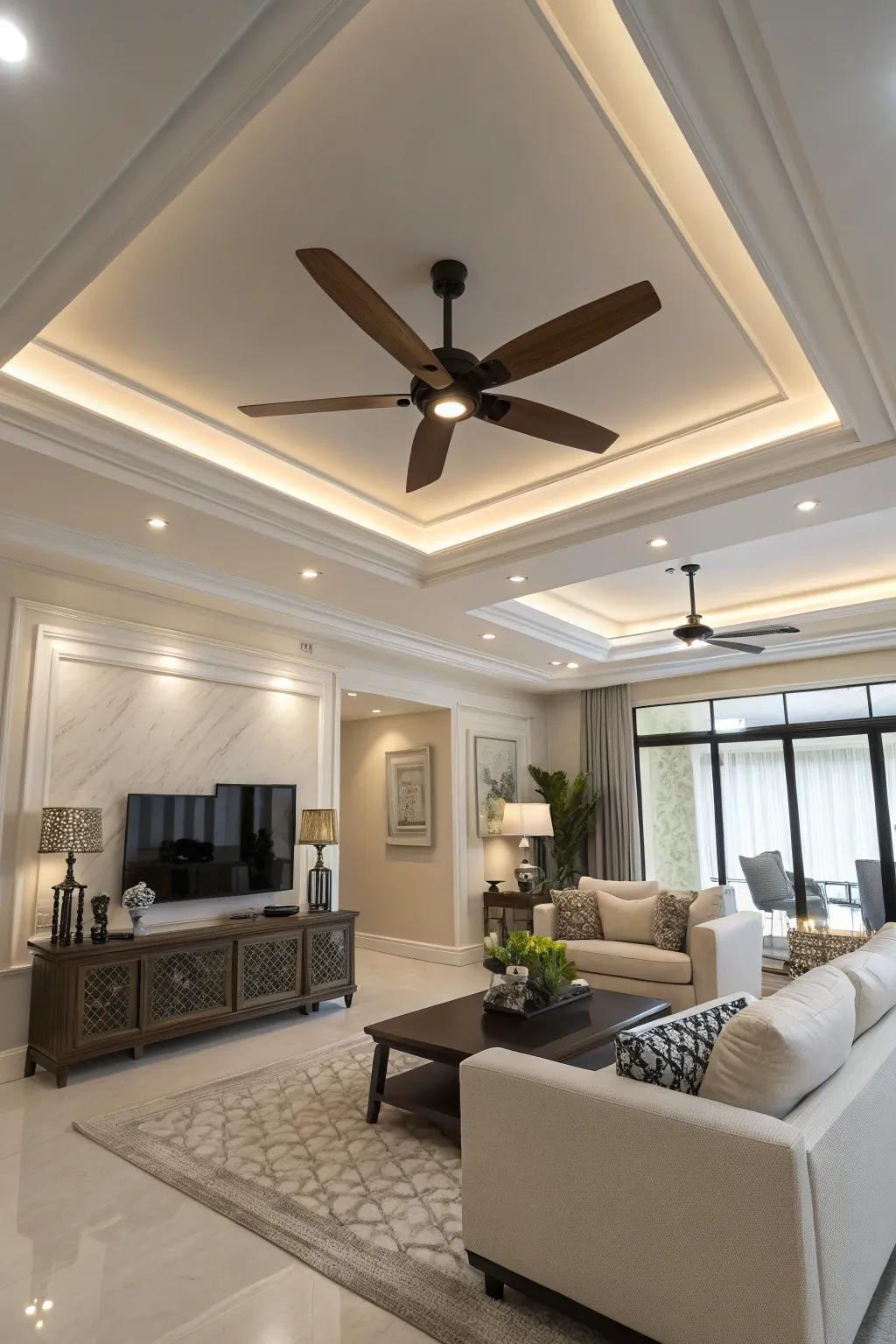 A modern living area features a sleek ceiling fan with lighting in the tray ceiling.