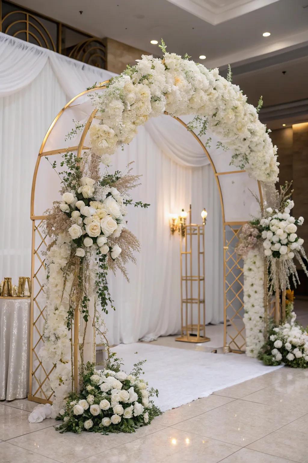 Grand entrance beneath a botanical arch in ivory and gold.