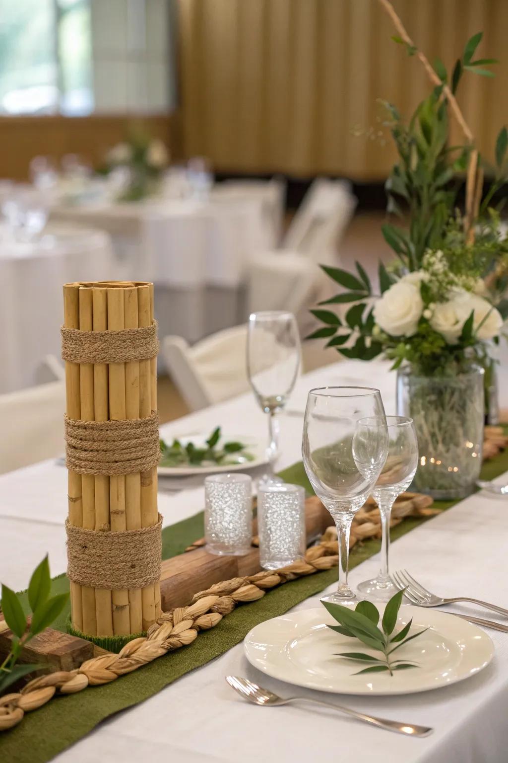 A bride and groom table featuring bamboo and repurposed glassware.