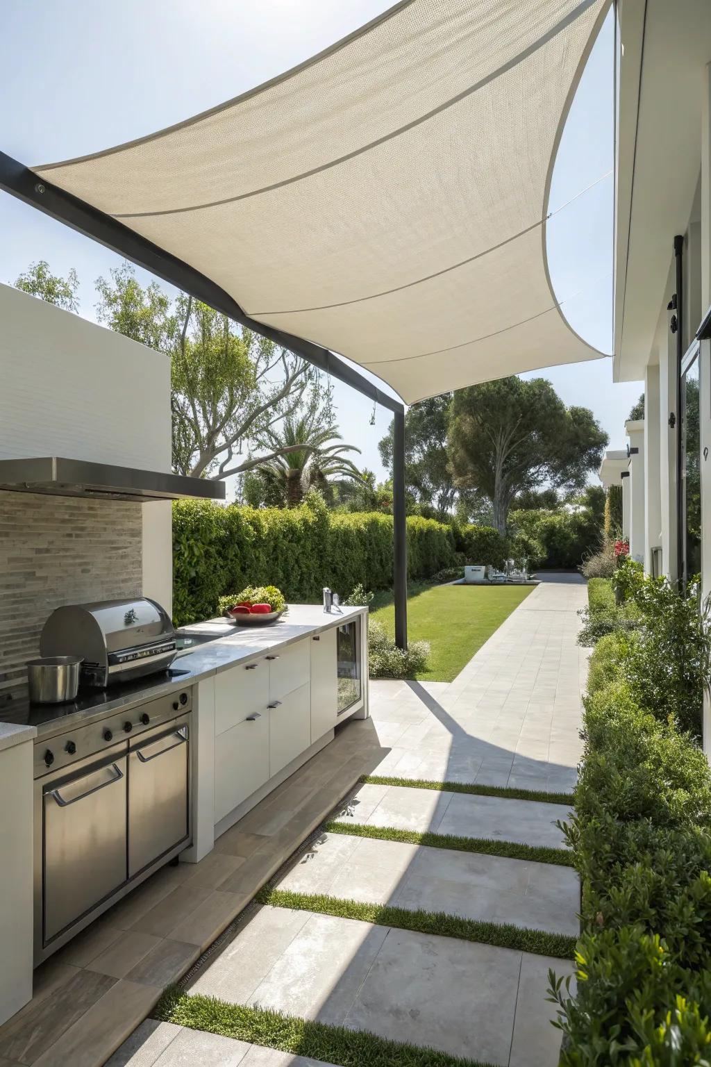 A sail shade delivers a streamlined and contemporary cover for your outdoor kitchen.
