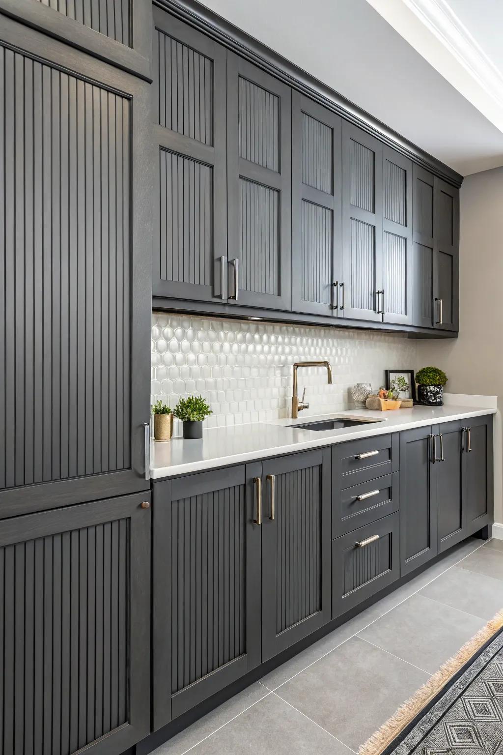 Vertical lines adding texture and height to the charcoal-toned cabinets.