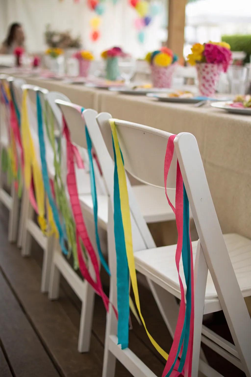Enhance chairs with multicolored ribbon aesthetic.