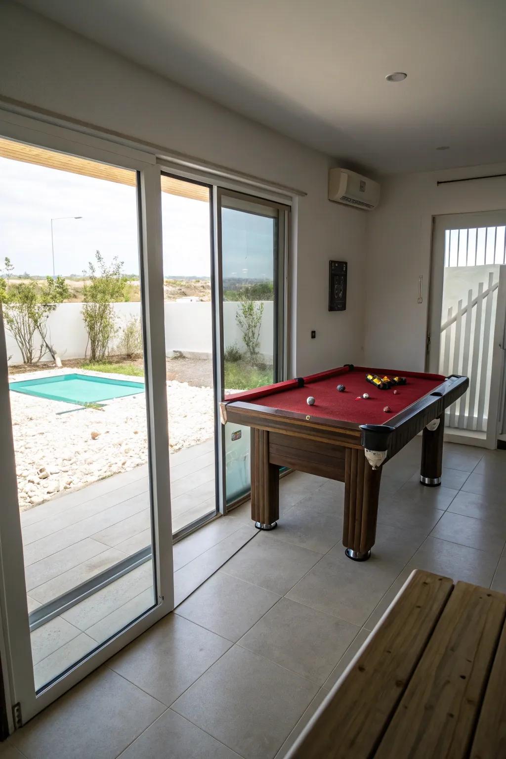 Gliding entrances conserve area and enhance accessibility in a small pool table room.