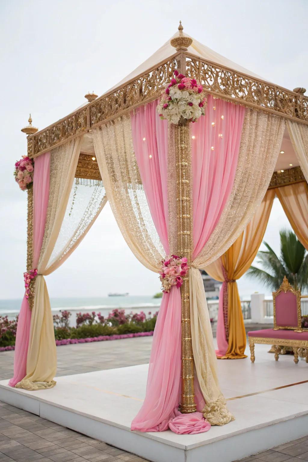 Sumptuous draped textiles in gold and rose enveloping a mandap.