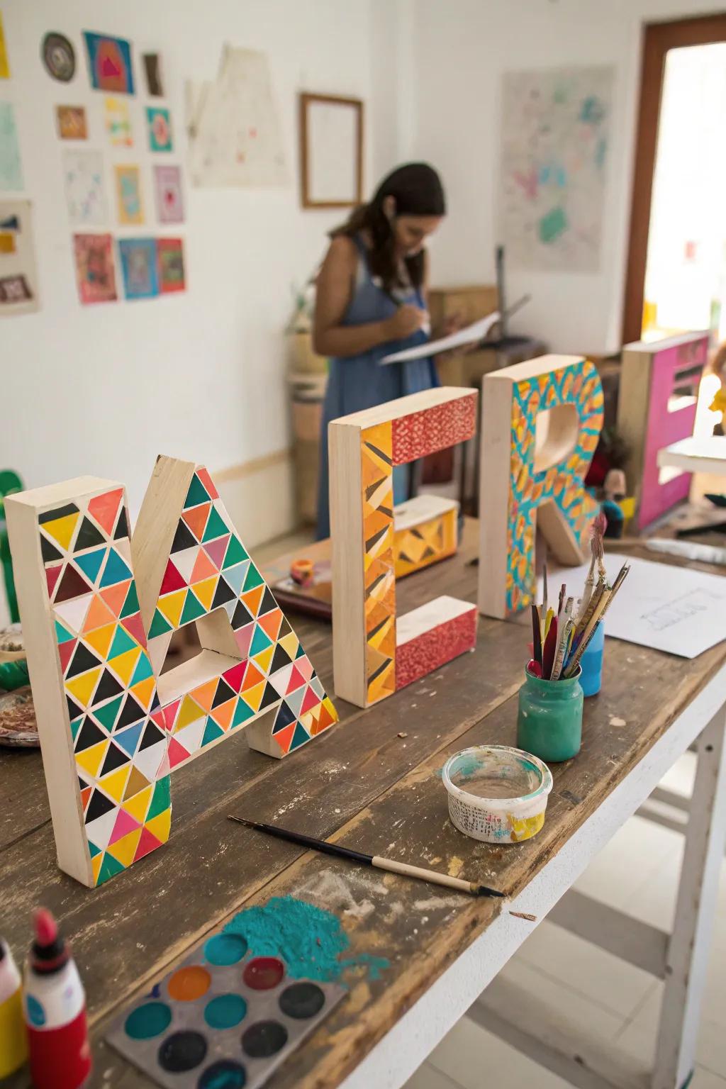Wooden letters painted with vibrant geometric patterns.