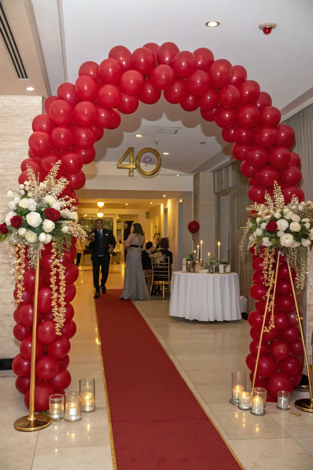 An archway of ruby-toned balloons makes a grand entrance statement.