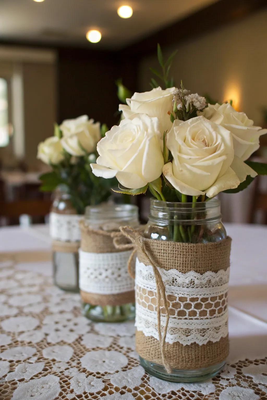 Elegant repurposed jars adorned with hessian and threaded lace.