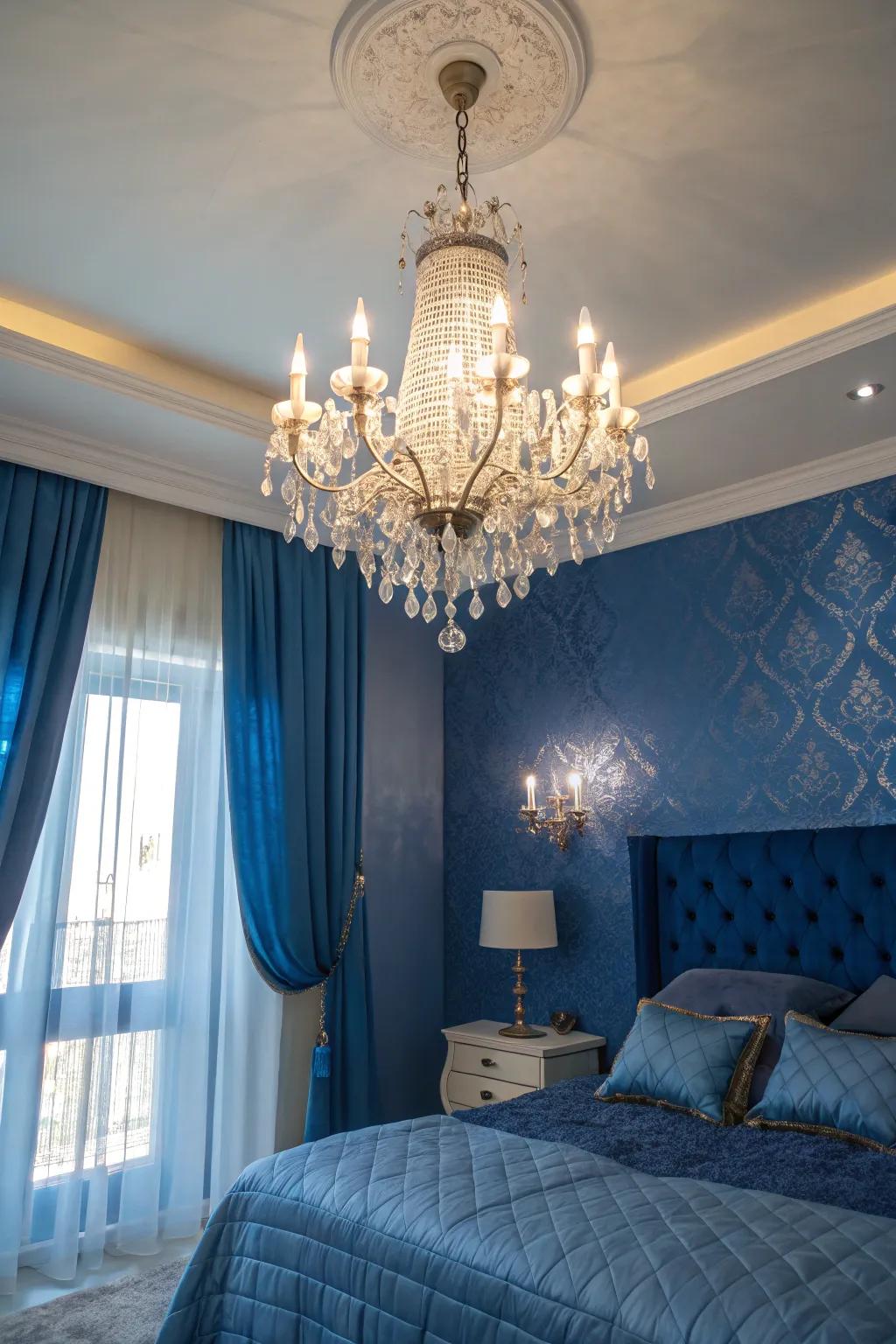 A crystal chandelier incorporates sophistication to a sapphire blue-themed bedroom.