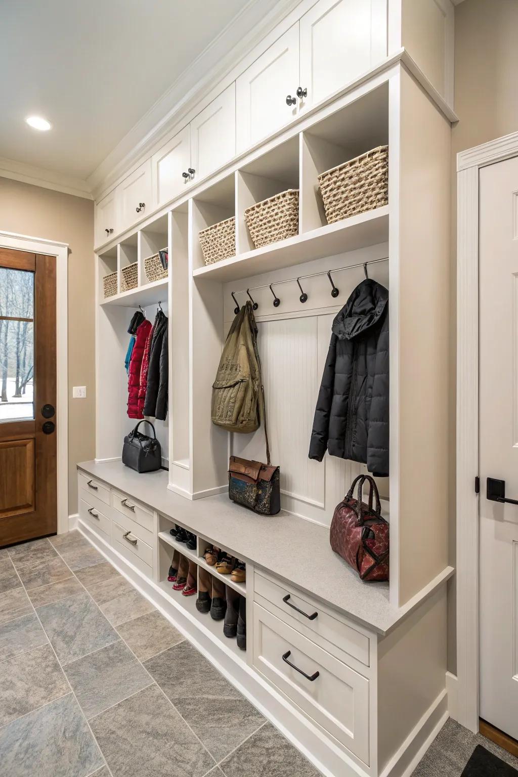 Hangers near cabinets provide effortless access for hanging coats and bags.