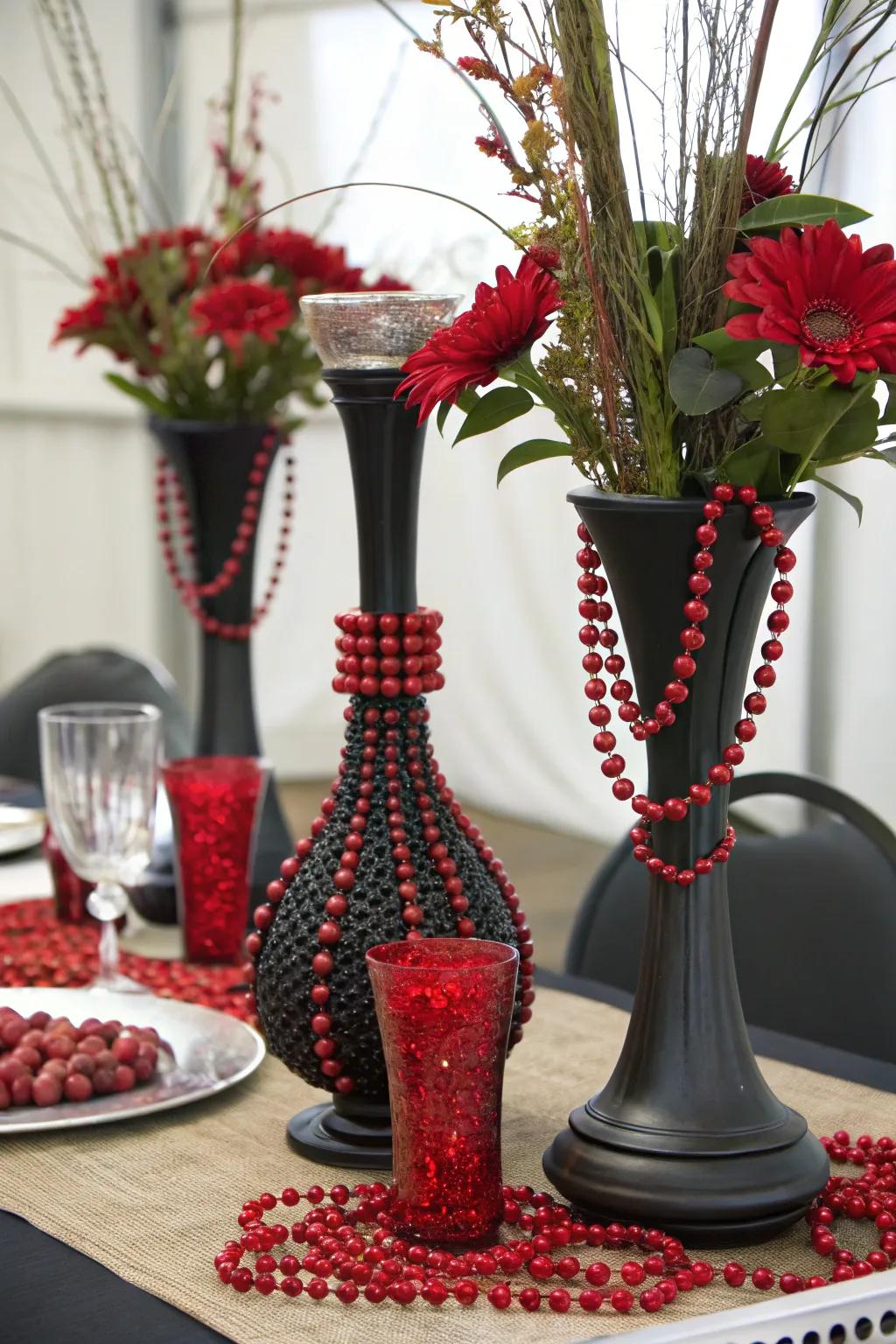 An assortment of materials incorporating dark fired clay and scarlet pearls to produce a richly textured centerpiece.