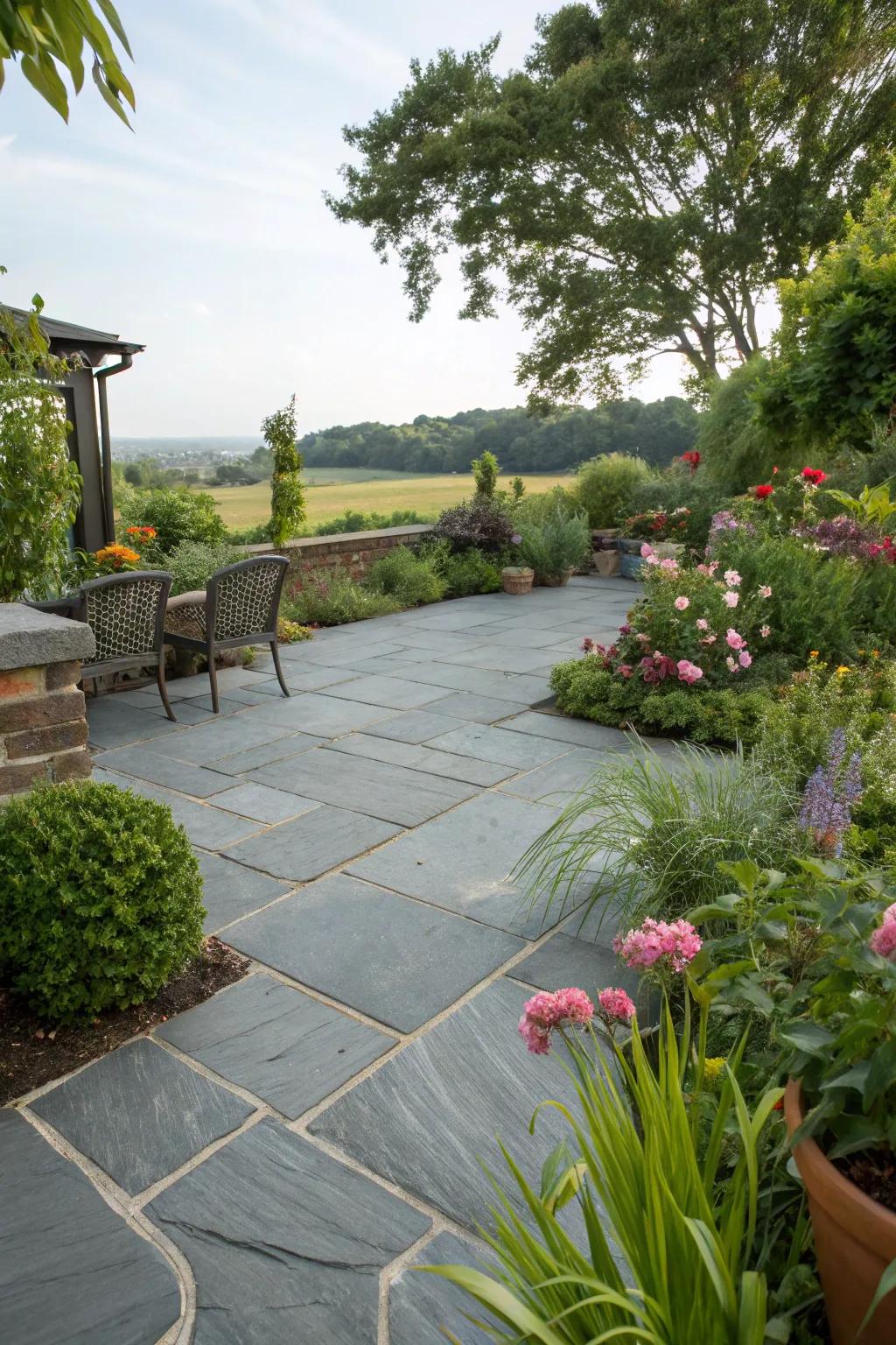 A slate patio beautifully integrated with lush landscaping.