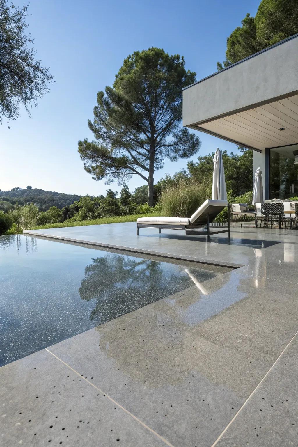 Refined concrete creates a sophisticated and contemporary look for the poolside.