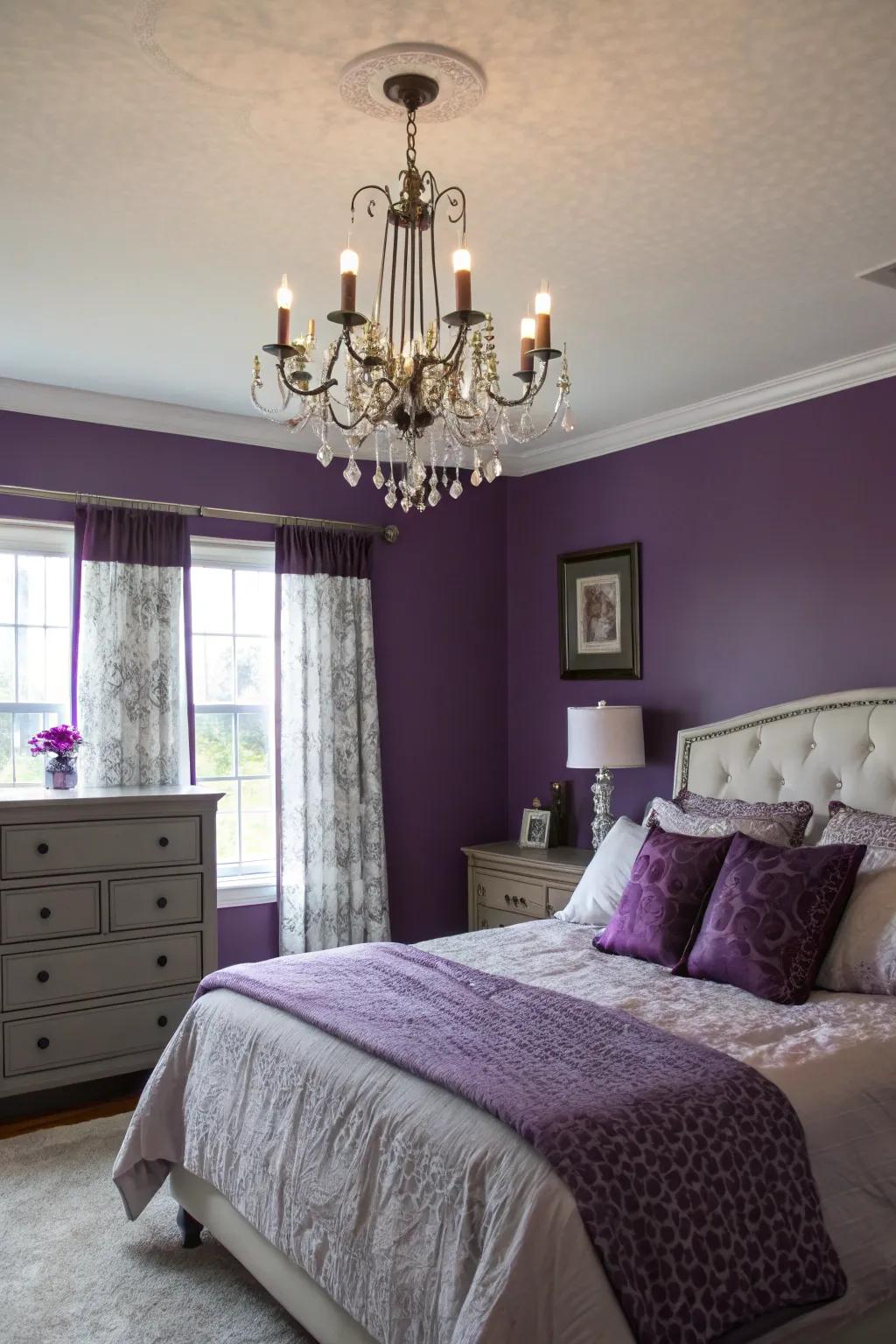 A statement chandelier elegantly illuminates purple walls.