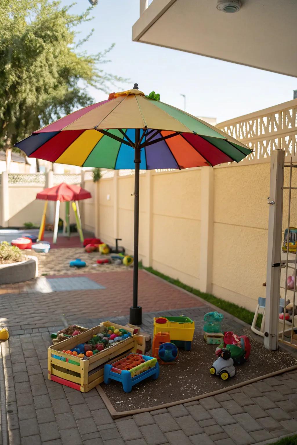 A shaded play area for kids with a colorful umbrella.