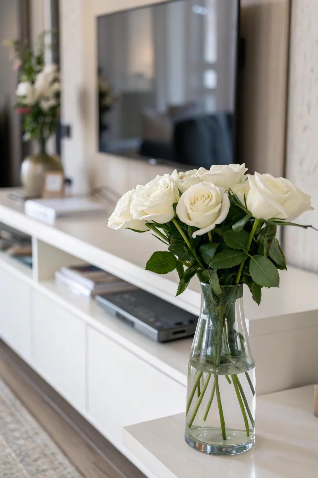Serenity through minimalist ivory roses within a clear vase.
