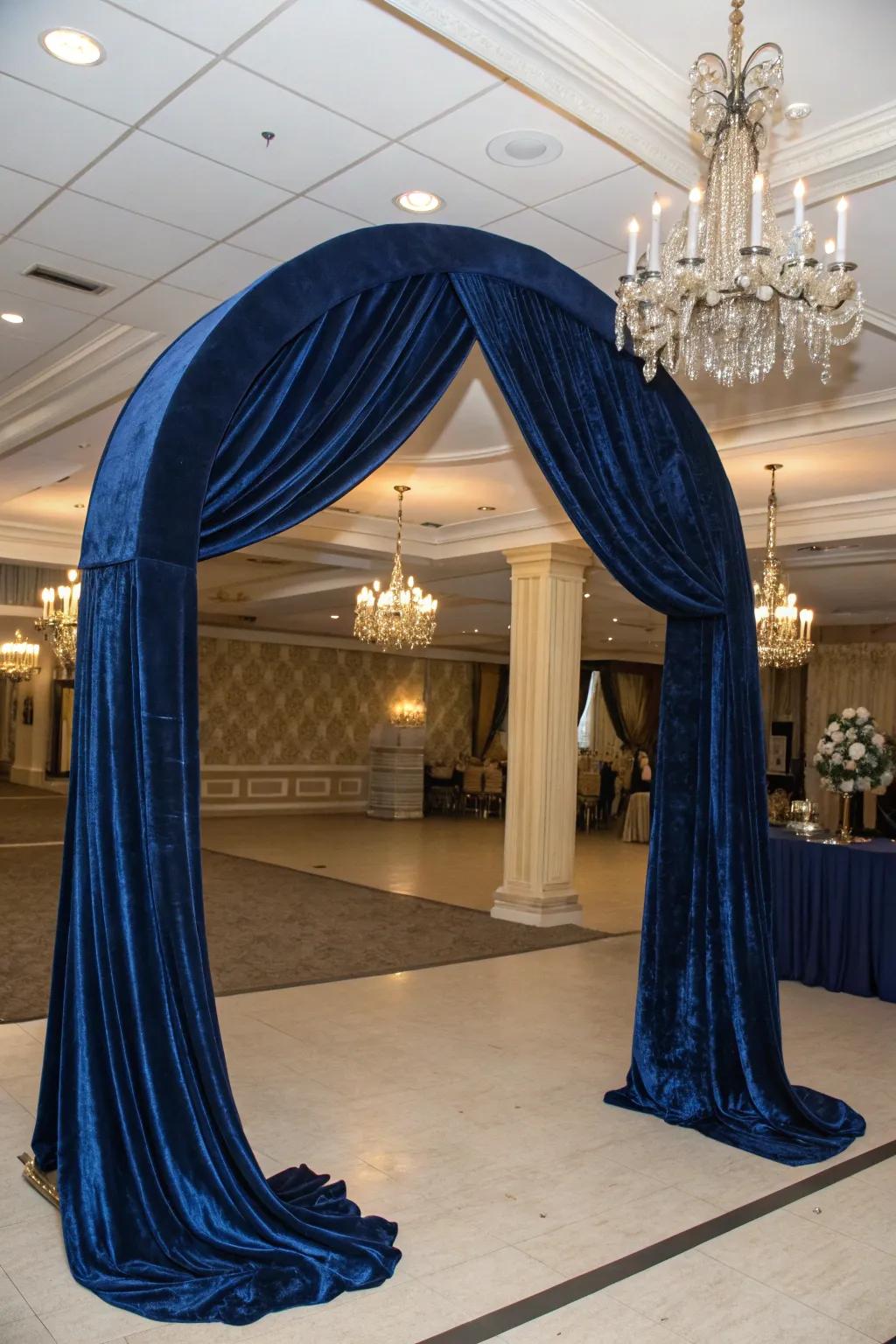 An elegant arch featuring opulent velvet drape for a dramatic statement.