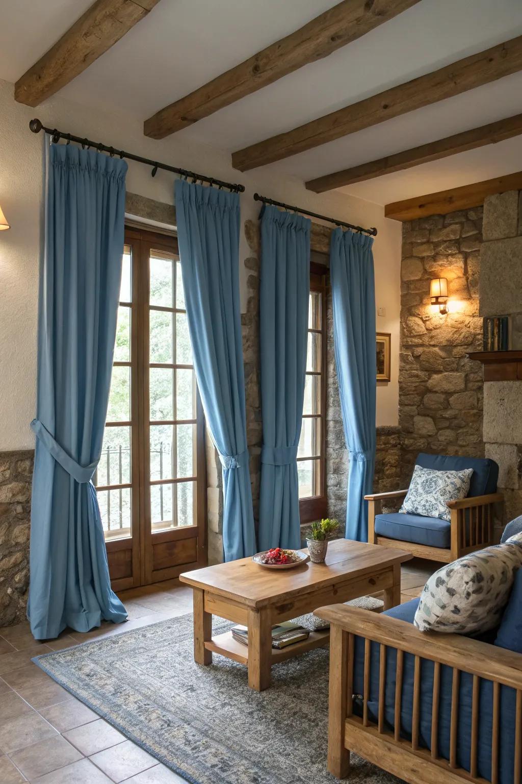 Organic elements such as timber and rock supplement azure window coverings, instilling warmth and textural quality to the room.